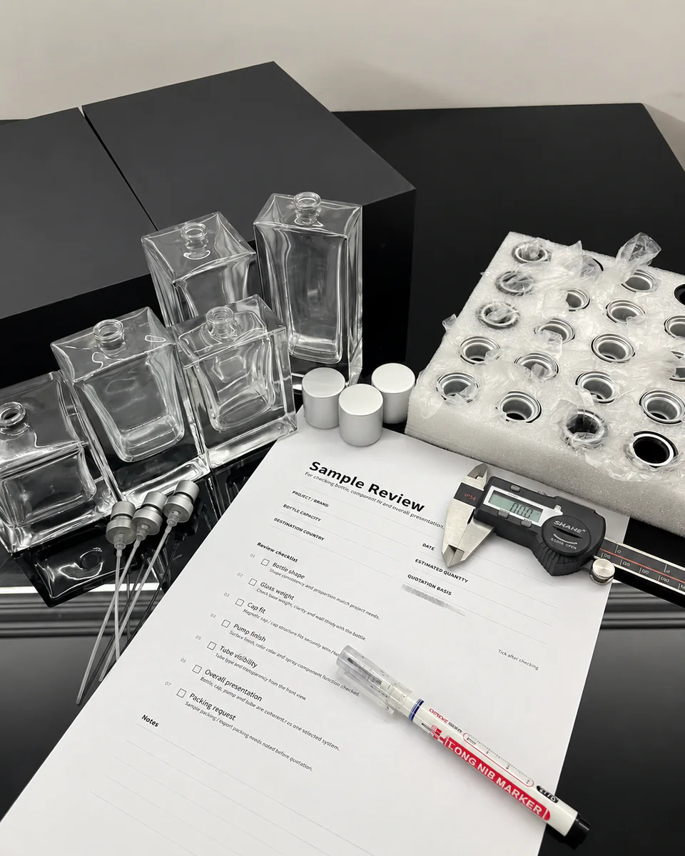 Perfume bottle samples, pumps, caps, caliper and review sheet on a workbench